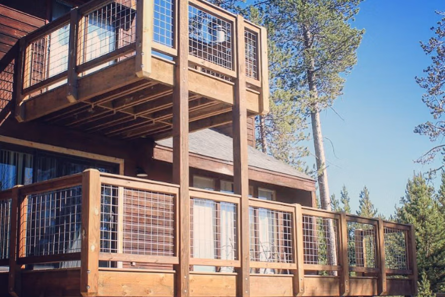 Deck and patio remodeling featuring sturdy wooden structures with wire mesh railings, designed for mountain living in Summit County, Colorado.